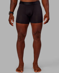 Man wearing MVP Trunks 3 Pack - Black/Cilantro/Midnight Blue | Thumbnail Index: 3