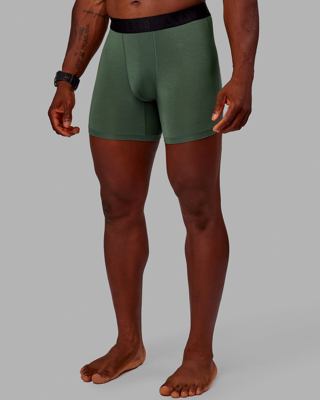Man wearing MVP Trunks 3 Pack - Black/Cilantro/Midnight Blue - view 8