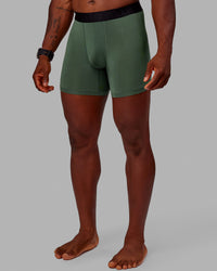 Man wearing MVP Trunks 3 Pack - Black/Cilantro/Midnight Blue | Thumbnail Index: 7