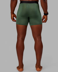 Man wearing MVP Trunks 3 Pack - Black/Cilantro/Midnight Blue | Thumbnail Index: 8
