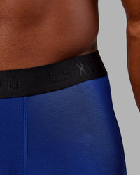 Man wearing MVP Trunks 3 Pack - Black/Cilantro/Midnight Blue | Thumbnail Index: 5