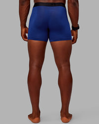 Man wearing MVP Trunks 3 Pack - Black/Cilantro/Midnight Blue | Thumbnail Index: 4