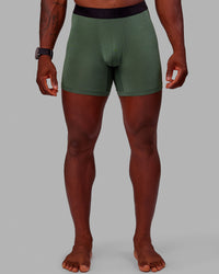 Man wearing MVP Trunks 3 Pack - Black/Cilantro/Midnight Blue | Thumbnail Index: 2