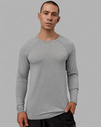 Man wearing AeroFLX+ Seamless Long Sleeve Tee - Light Grey Marl | Thumbnail Index: 1