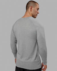 Man wearing AeroFLX+ Seamless Long Sleeve Tee - Light Grey Marl | Thumbnail Index: 2