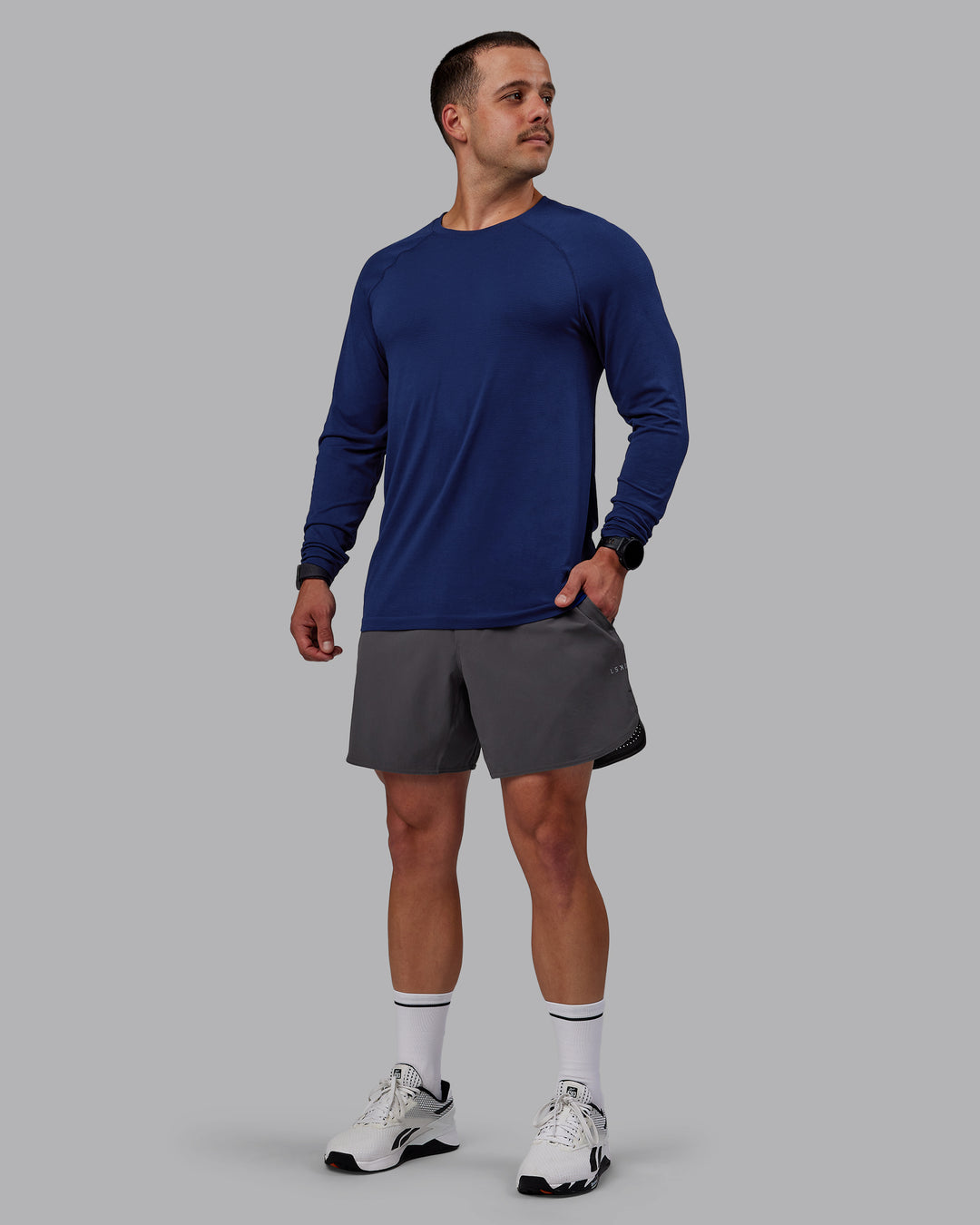 Man wearing AeroFLX+ Seamless Long Sleeve Tee - Midnight Blue/Midnight Blue Marl - view 1