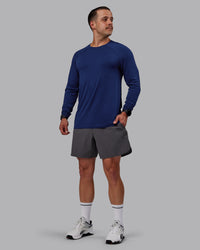 Man wearing AeroFLX+ Seamless Long Sleeve Tee - Midnight Blue/Midnight Blue Marl | Thumbnail Index: 0