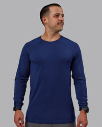 Man wearing AeroFLX+ Seamless Long Sleeve Tee - Midnight Blue/Midnight Blue Marl | Thumbnail Index: 1
