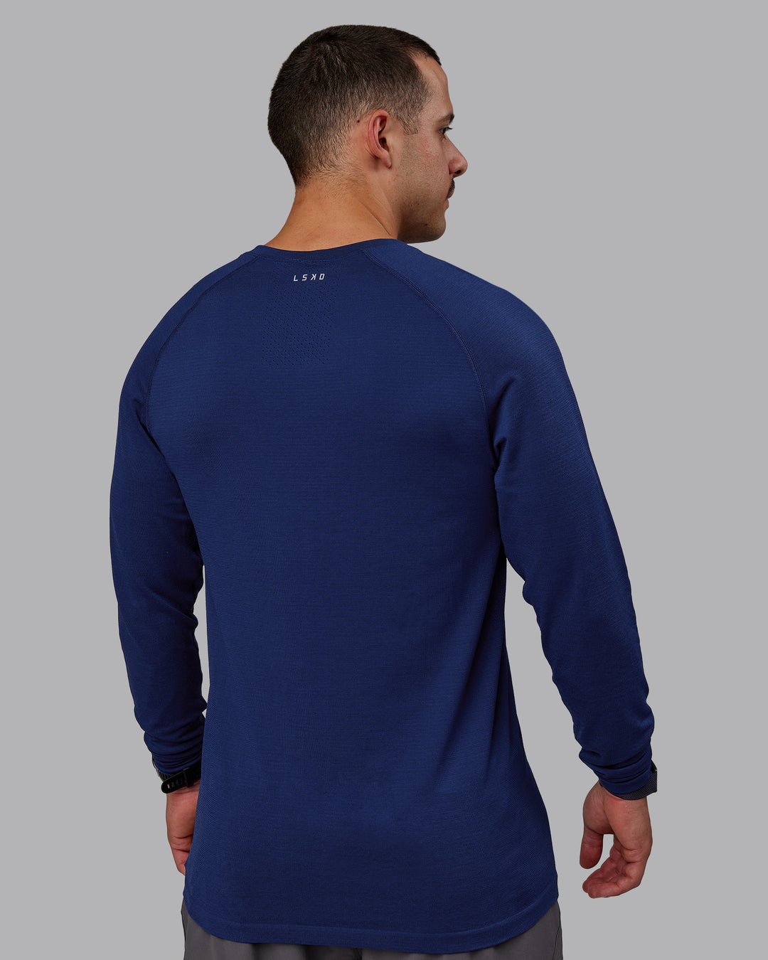 Man wearing AeroFLX+ Seamless Long Sleeve Tee - Midnight Blue/Midnight Blue Marl - view 4