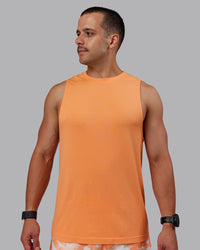 Man wearing AeroFLX+ Seamless Muscle Tank - Cantaloupe/Cantaloupe Marl | Thumbnail Index: 1