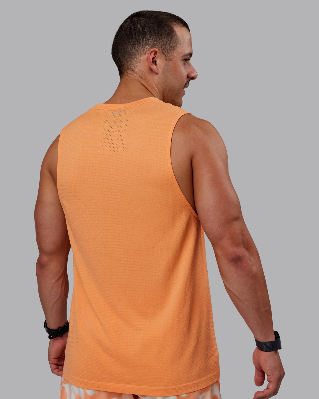 Man wearing AeroFLX+ Seamless Muscle Tank - Cantaloupe/Cantaloupe Marl - view 4