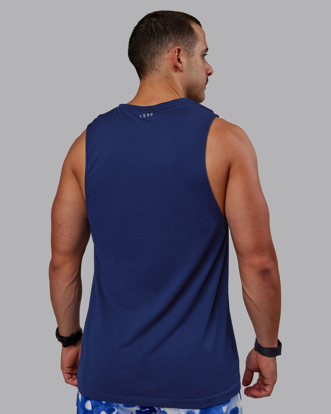 Man wearing AeroFLX+ Seamless Muscle Tank - Midnight Blue/Midnight Blue Marl - view 3