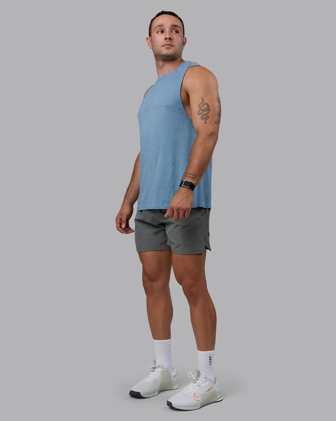 Man wearing AeroFLX+ Seamless Muscle Tank - Elemental Blue/Ice Blue - view 2
