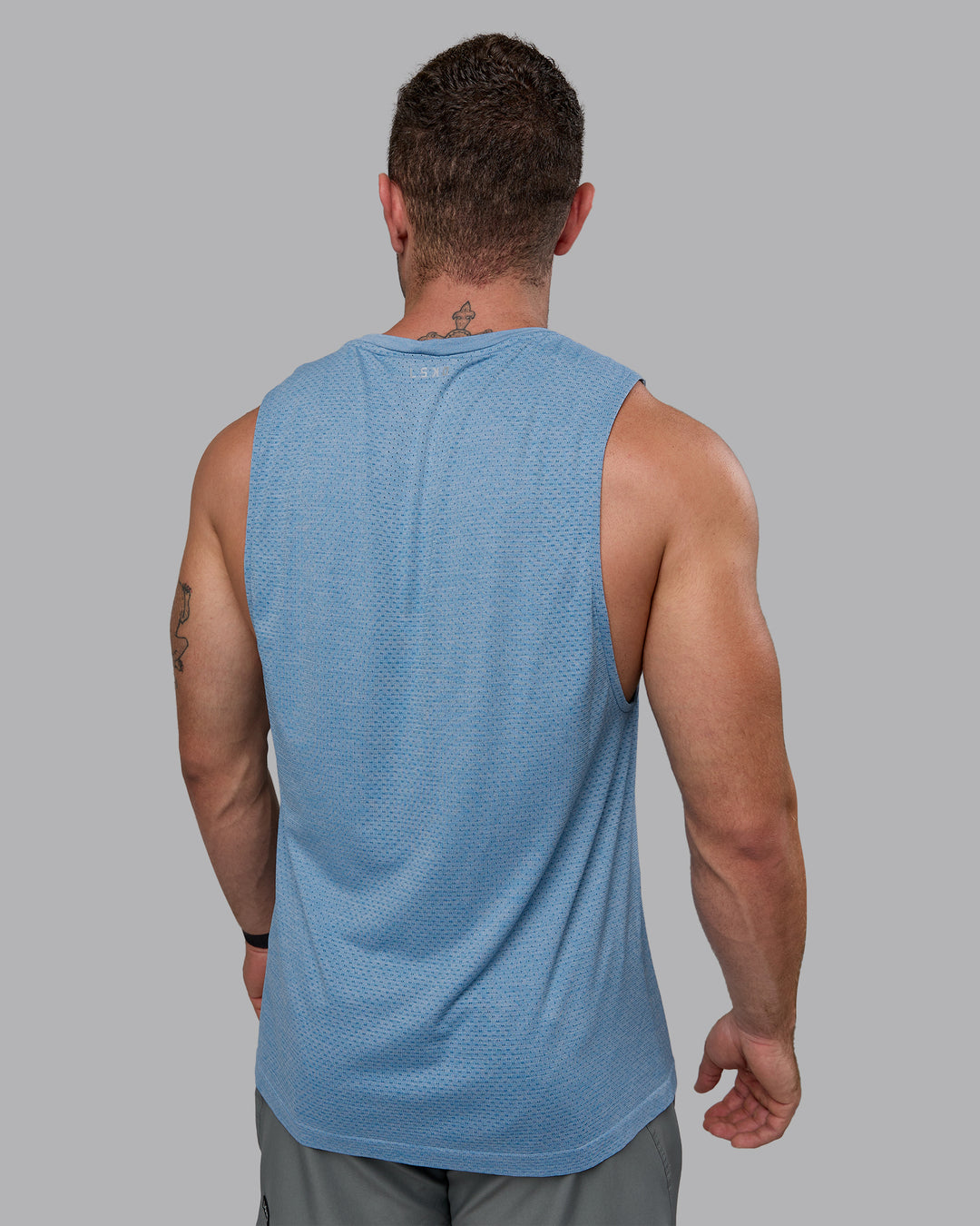 Man wearing AeroFLX+ Seamless Muscle Tank - Elemental Blue/Ice Blue - view 4