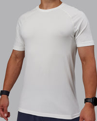 Man wearing AeroFLX+ Seamless Tee - Off White/Off White Marl | Thumbnail Index: 4