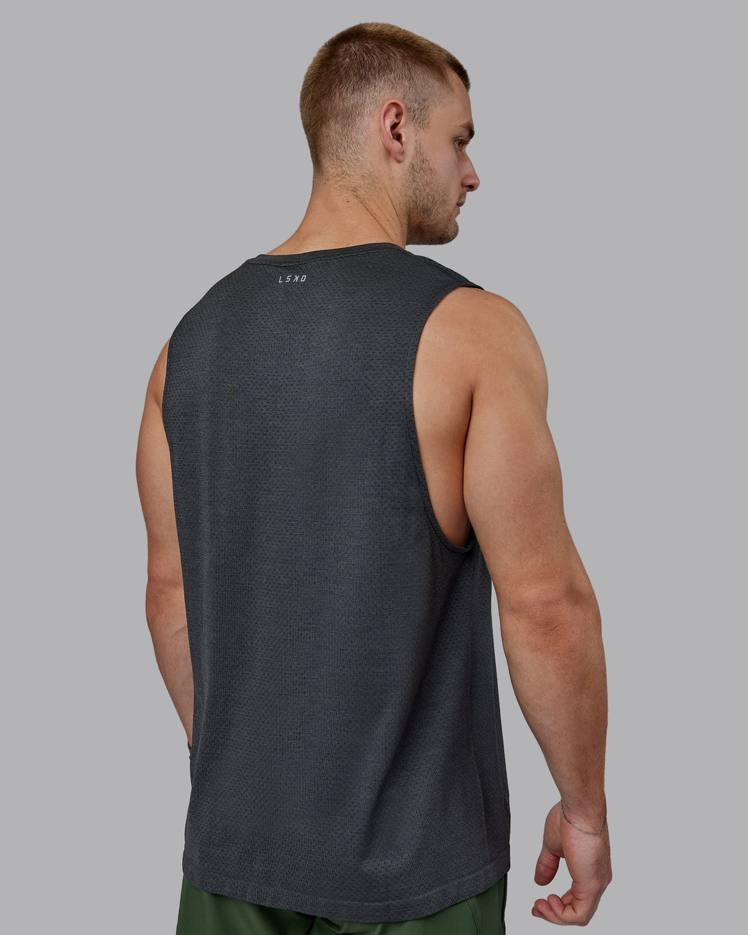 Man wearing AeroFLX+ Seamless Muscle Tank - Pirate Black Marl - view 8