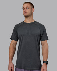 Man wearing AeroFLX+ Seamless Tee - Pirate Black Marl | Thumbnail Index: 1