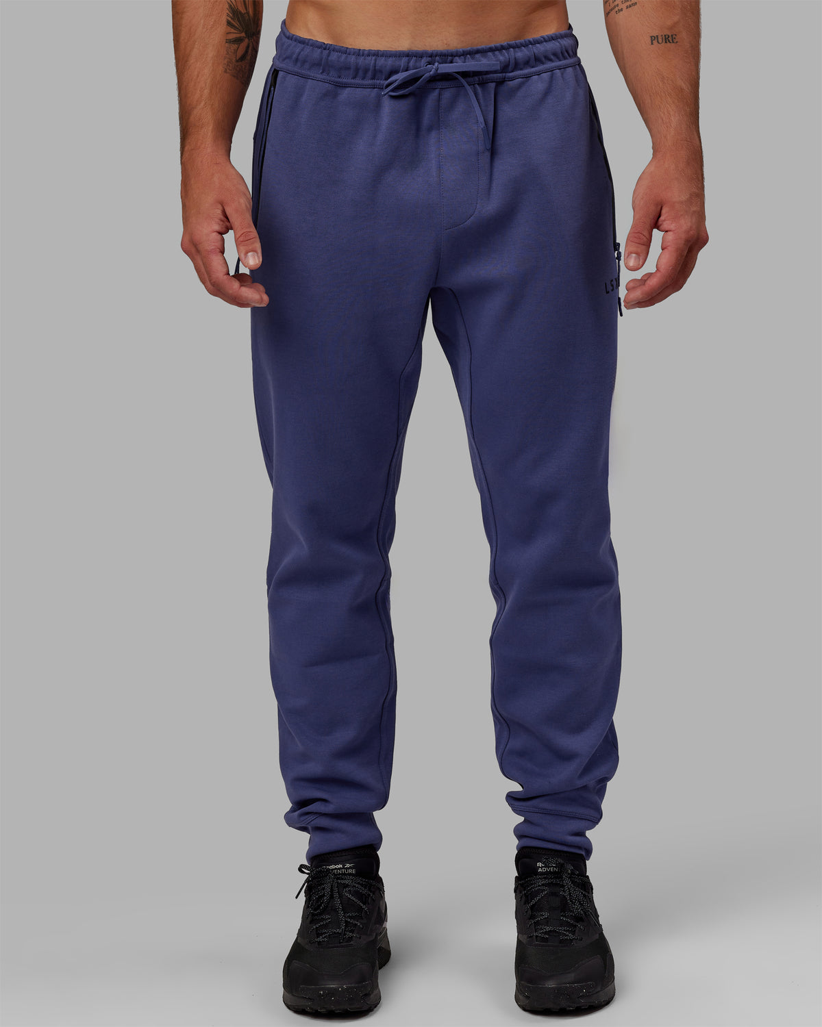 Man wearing Athlete ForgedFleece Zip Track Pants - Future Dusk