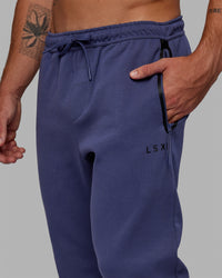Man wearing Athlete ForgedFleece Zip Track Pants - Future Dusk | Thumbnail Index: 2