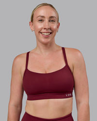 Woman wearing Momentum Sports Bra (D/DD/E) - Cordovan | Thumbnail Index: 0
