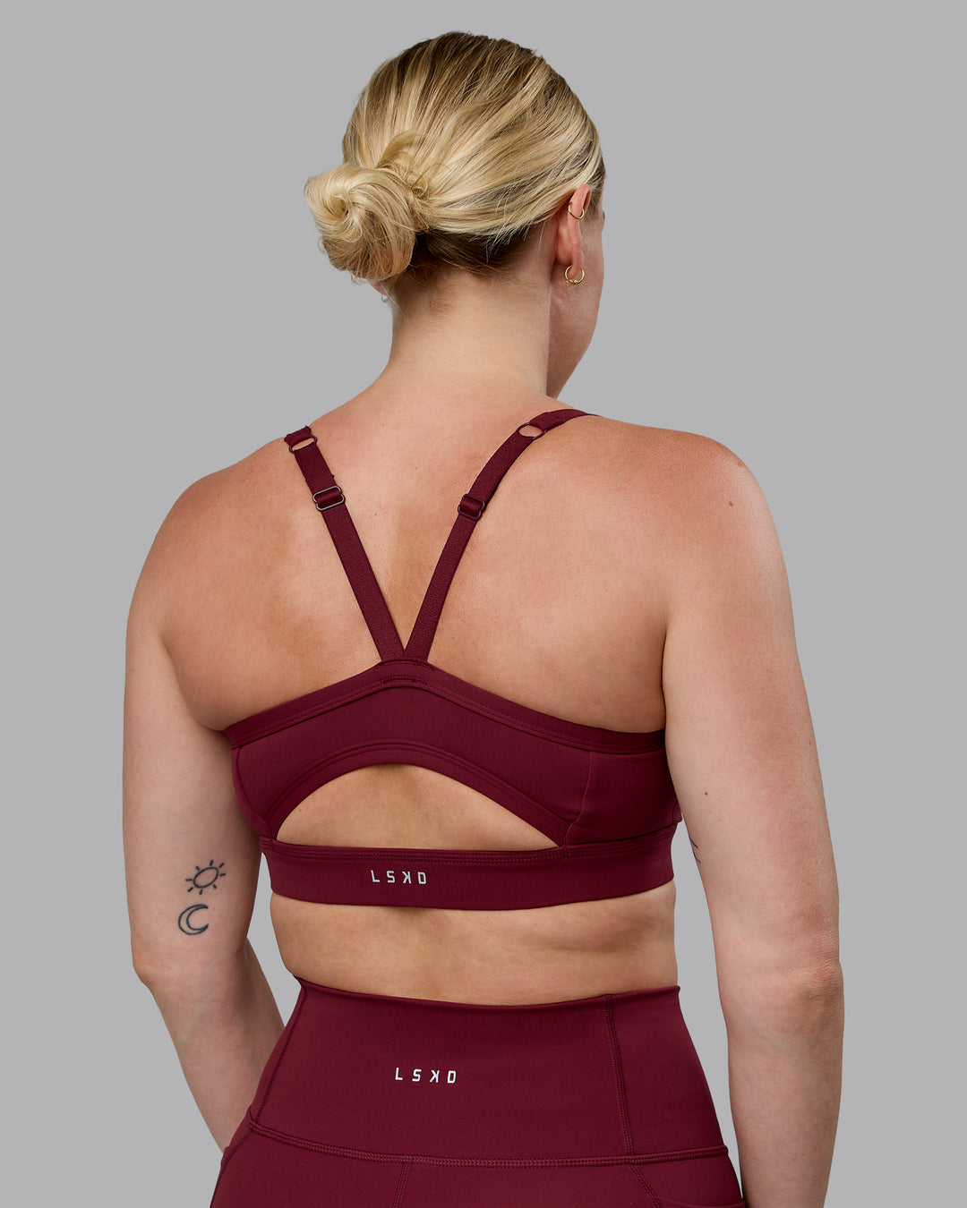 Woman wearing Momentum Sports Bra (D/DD/E) - Cordovan - view 2