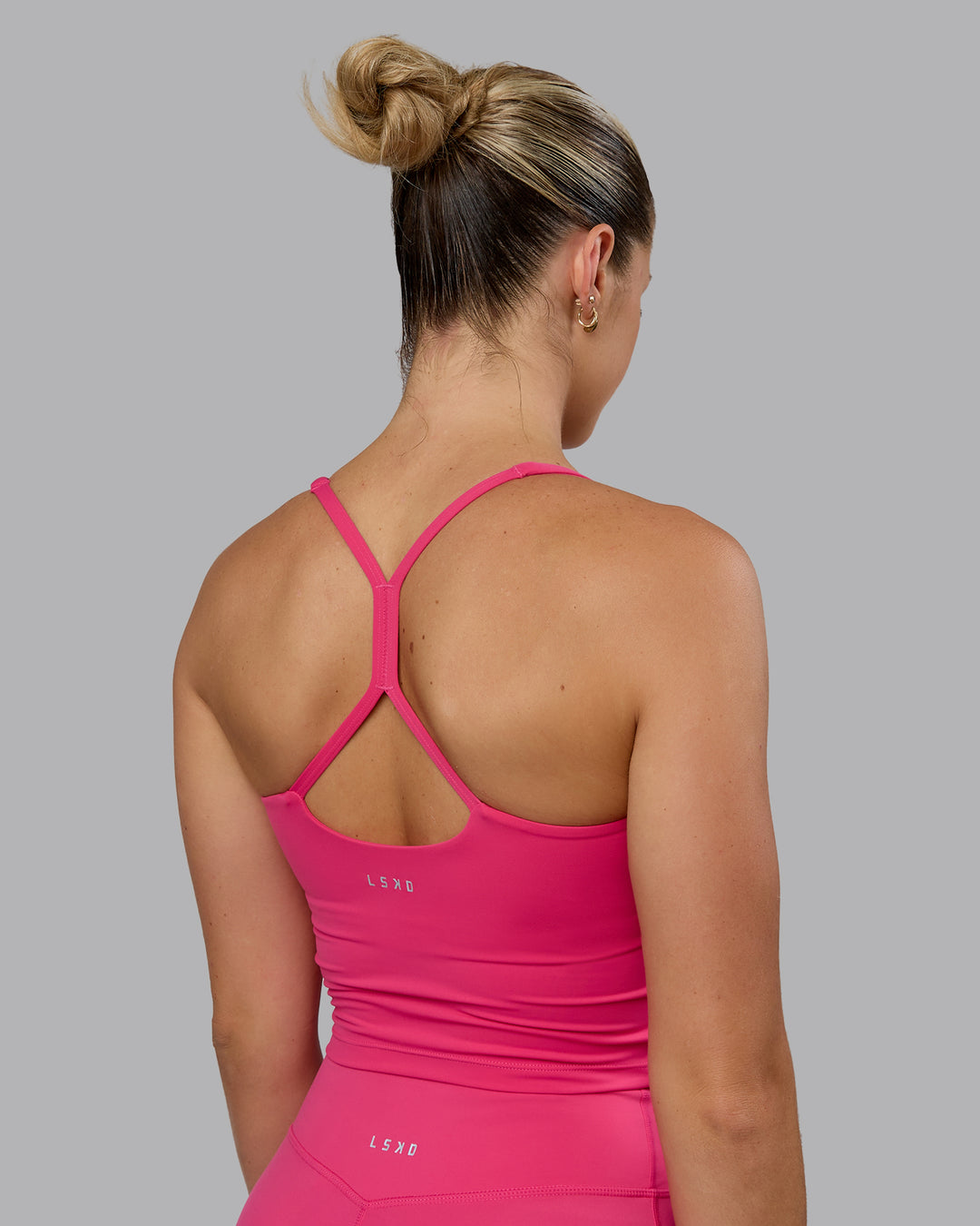 Woman wearing Movement Active Tank - Pink Flash - view 2