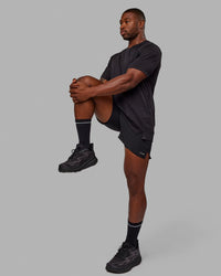 Man wearing Pace 5" Lined Performance Shorts - Black-Reflective | Thumbnail Index: 2