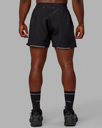 Man wearing Pace 5" Lined Performance Shorts - Black-Reflective | Thumbnail Index: 6