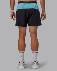 Man wearing Pace 5" Lined Performance Shorts - Black-Retro Blue | Thumbnail Index: 7