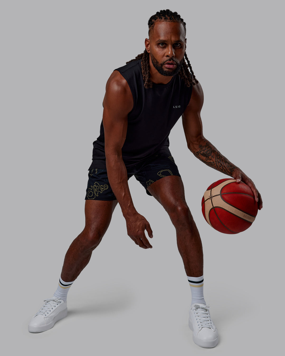 Man wearing Patty Mills Challenger 6" Performance Shorts - Black-Vital Green - view 8