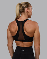 Woman wearing Precision Sports Bra - Black | Thumbnail Index: 1