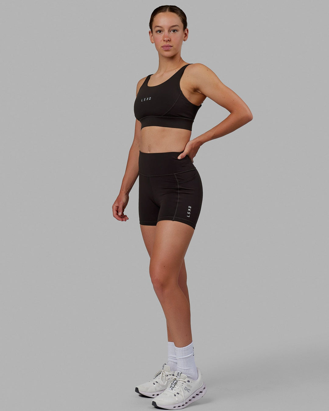 Woman wearing Propel Sports Bra - Dark Walnut - view 6