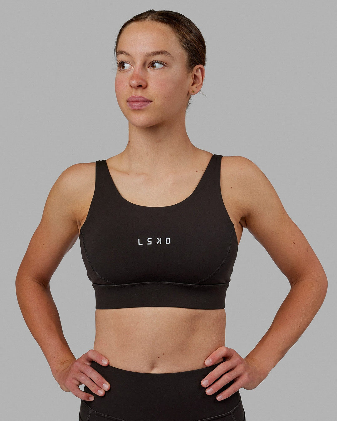 Woman wearing Propel Sports Bra - Dark Walnut - view 5