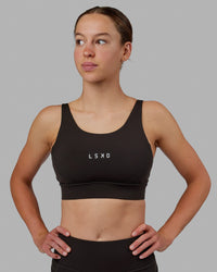 Woman wearing Propel Sports Bra - Dark Walnut | Thumbnail Index: 4