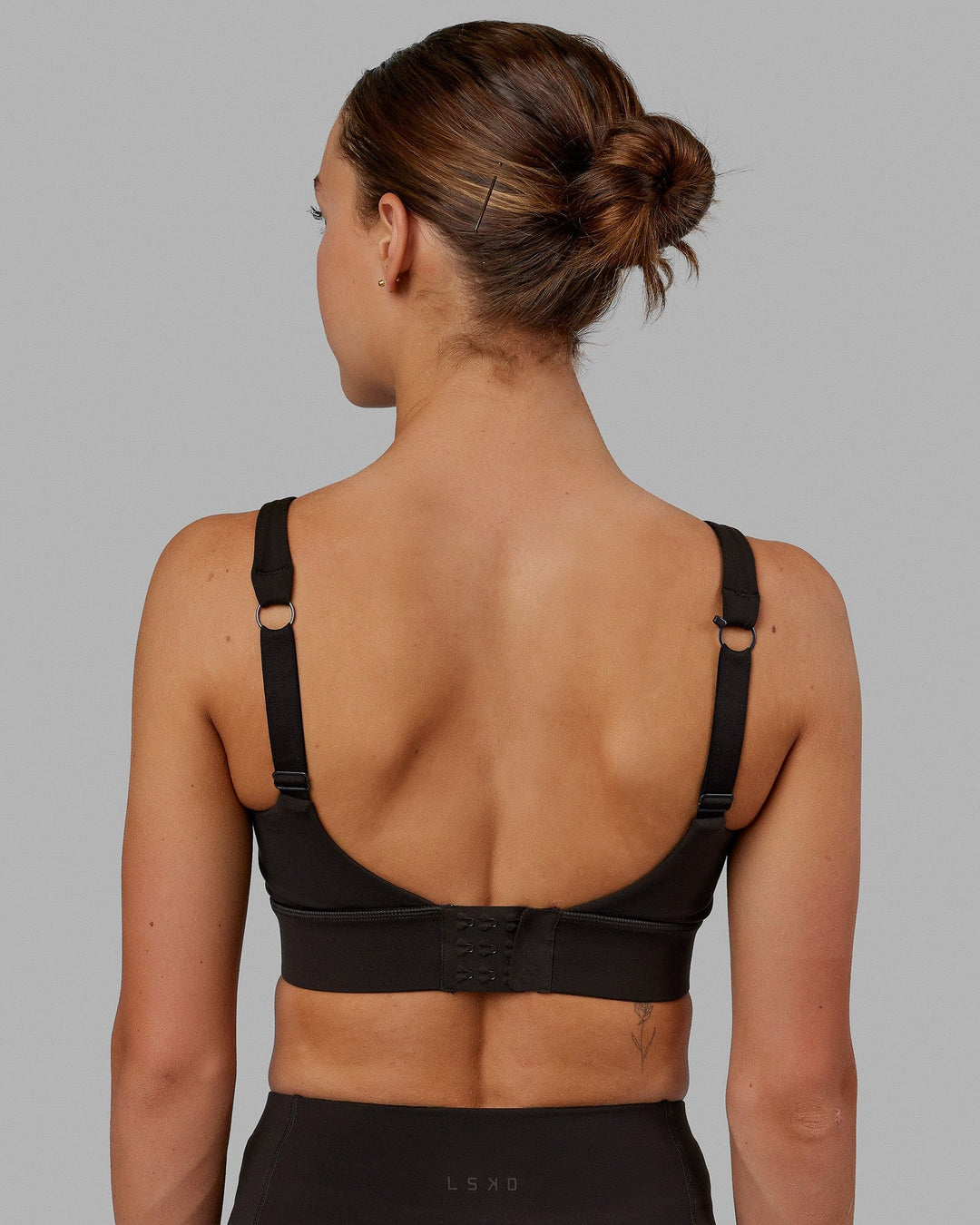 Woman wearing Propel Sports Bra - Dark Walnut - view 2