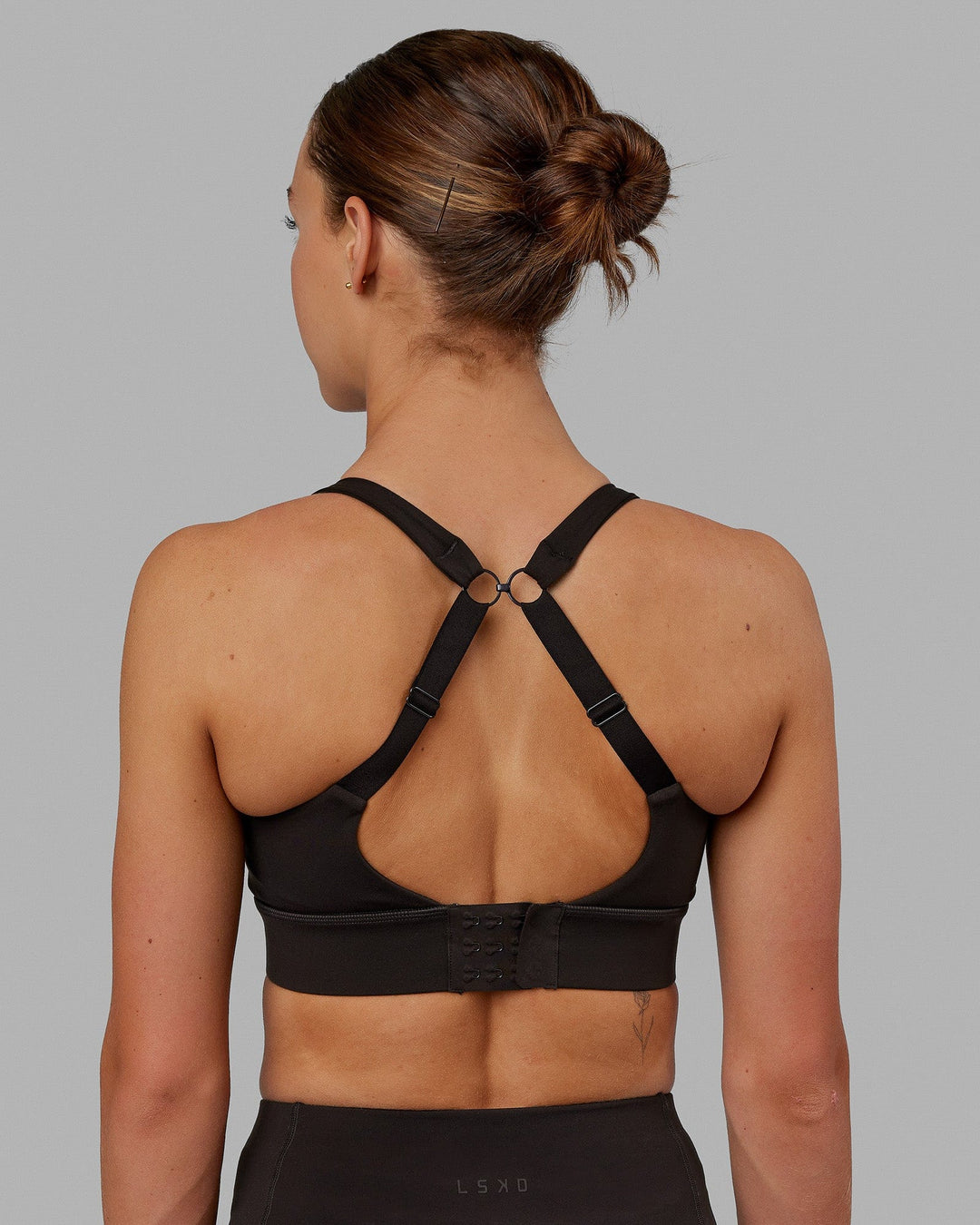 Woman wearing Propel Sports Bra - Dark Walnut - view 7