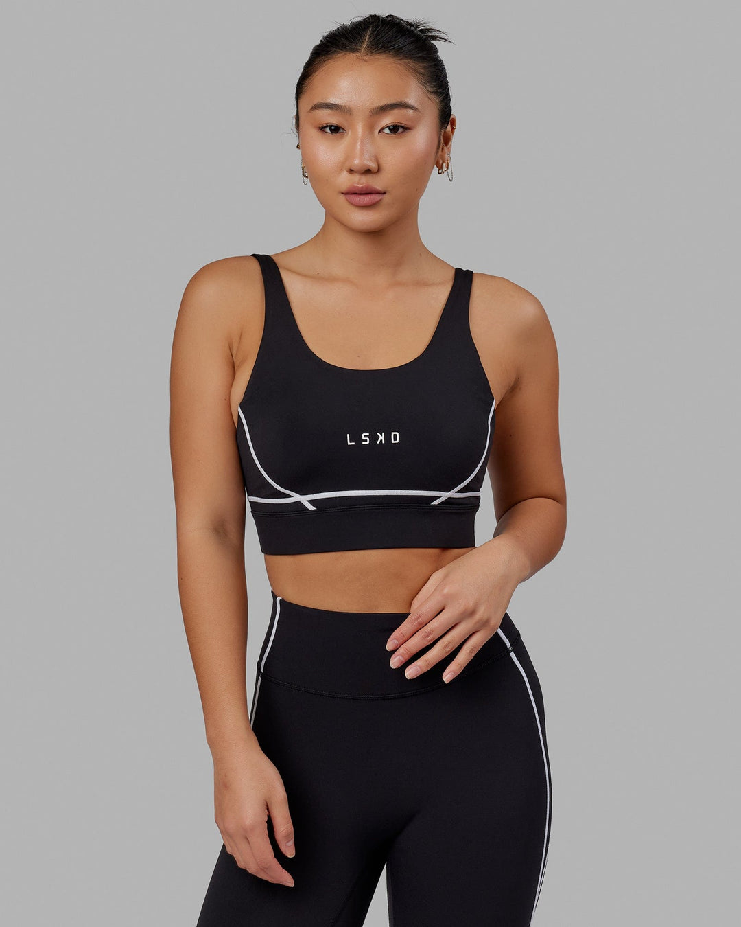 Woman wearing Pulse Sports Bra - Black - view 1