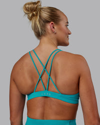 Woman wearing Pursue Sports Bra - Blue Bird | Thumbnail Index: 1