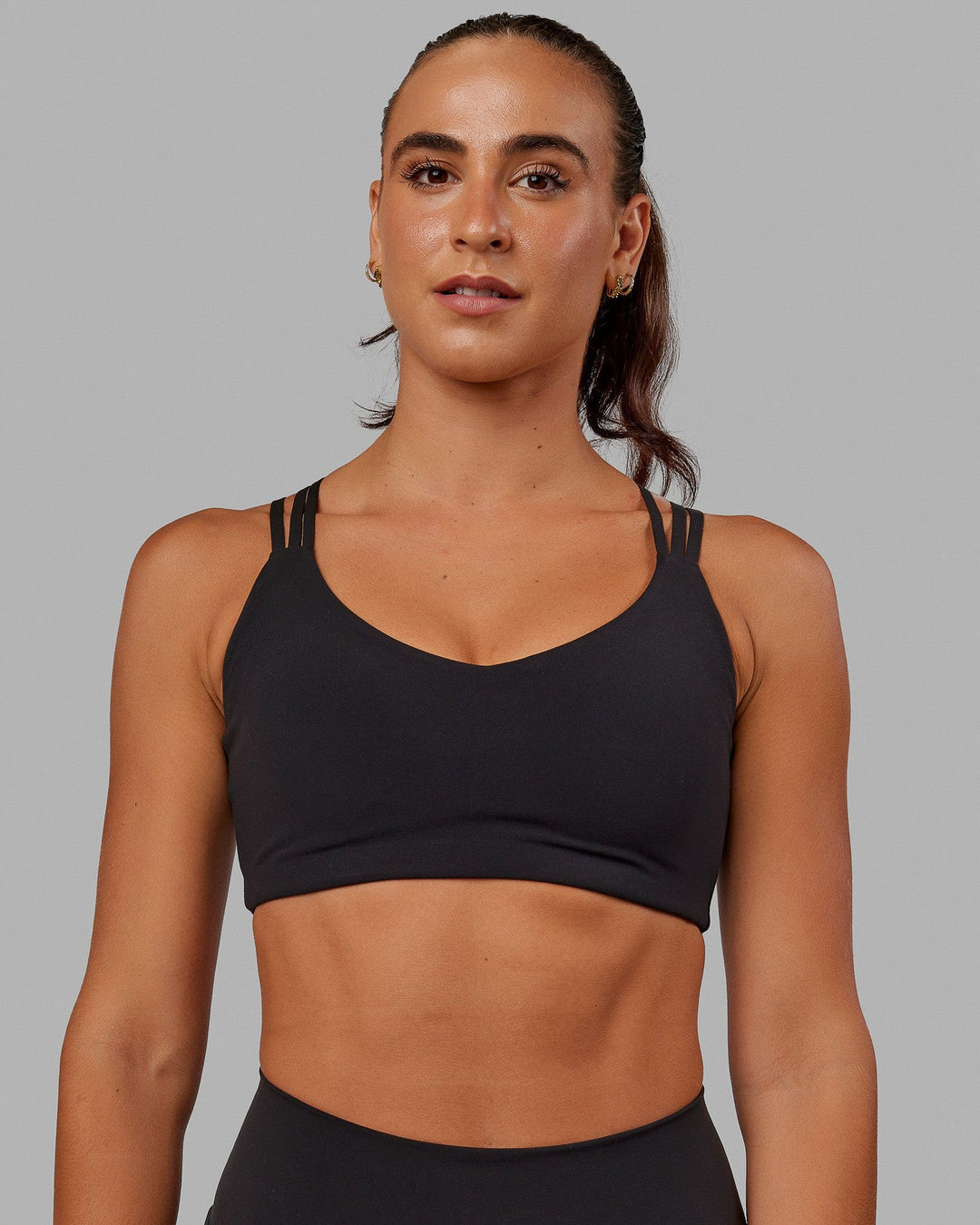 Woman wearing Push The Limit Sports Bra - Black - view 1