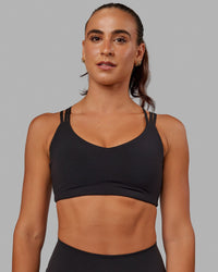 Woman wearing Push The Limit Sports Bra - Black | Thumbnail Index: 0