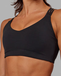 Woman wearing Push The Limit Sports Bra - Black | Thumbnail Index: 4