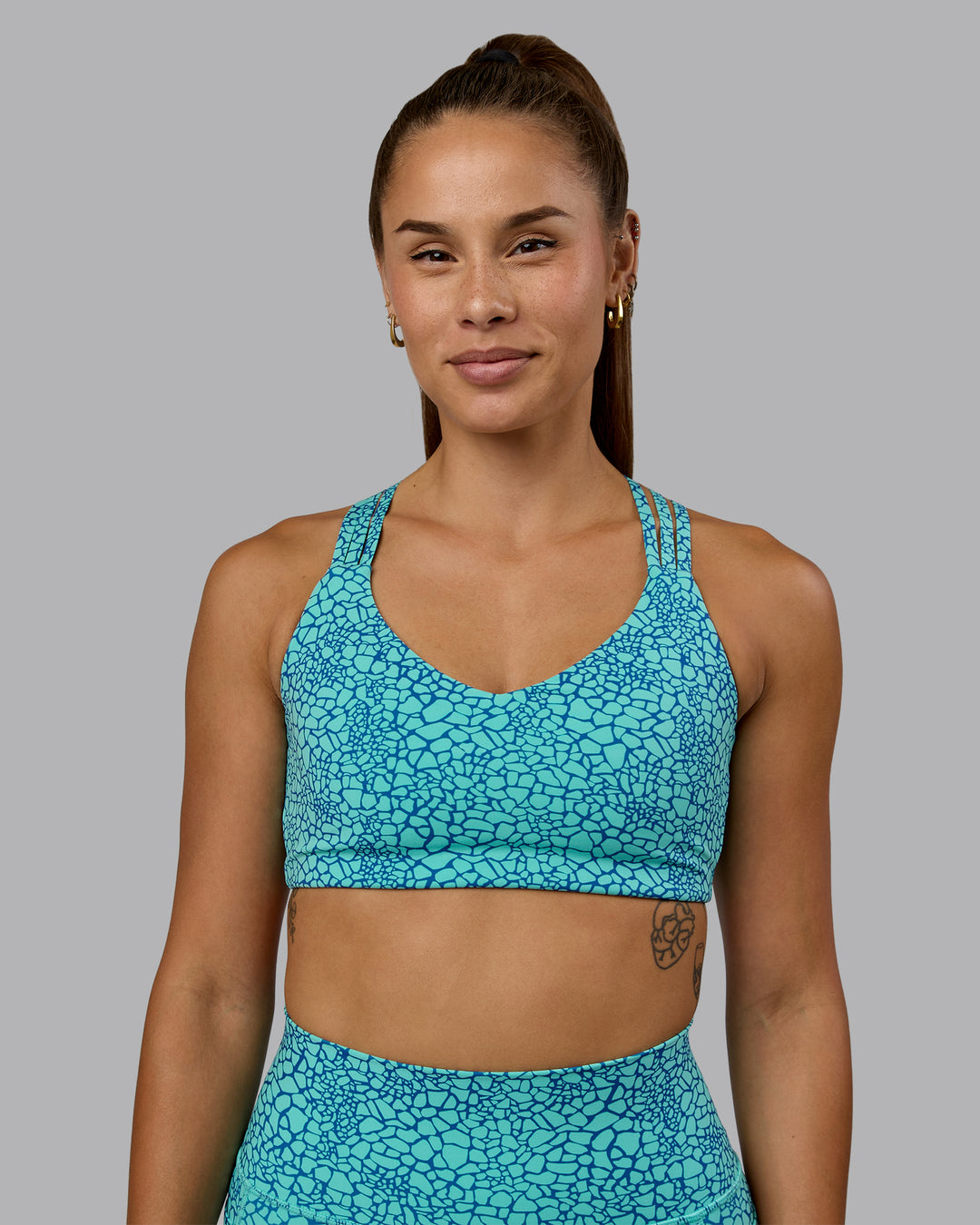 Woman wearing Push The Limit Sports Bra - Aquatic Awe Vitality Print - view 5