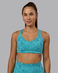 Woman wearing Push The Limit Sports Bra - Aquatic Awe Vitality Print | Thumbnail Index: 4