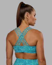 Woman wearing Push The Limit Sports Bra - Aquatic Awe Vitality Print | Thumbnail Index: 0