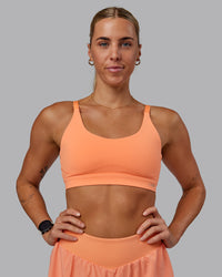 Woman wearing Rapid Sports Bra - Cantaloupe | Thumbnail Index: 4