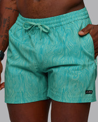 Man wearing Rep 5" Performance Shorts - Topographic Blue Bird | Thumbnail Index: 1
