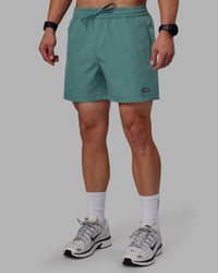 Man wearing Rep 5" Performance Shorts - Sage Bush | Thumbnail Index: 0