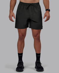 Man wearing Rep 7" Performance Shorts - Pirate Black | Thumbnail Index: 2