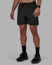 Man wearing Rep 7" Performance Shorts - Pirate Black | Thumbnail Index: 1
