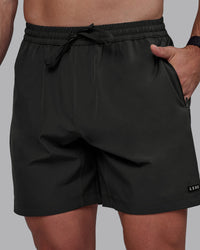 Man wearing Rep 7" Performance Shorts - Pirate Black | Thumbnail Index: 0